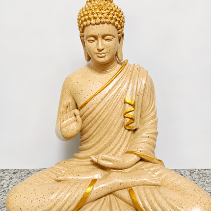 Beige and golden sitting Buddha statue for home decoration