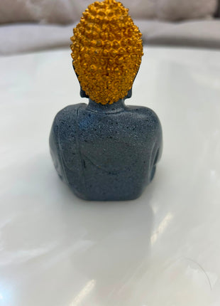 ark grey meditating Buddha statue with golden headpiece for home décor